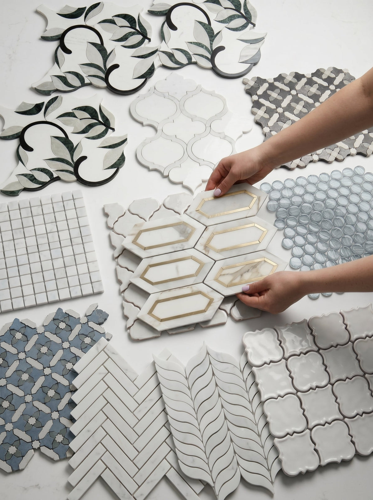 Hands selecting unique mosaic tiles from a variety of patterns in a clearance home decor deals display.