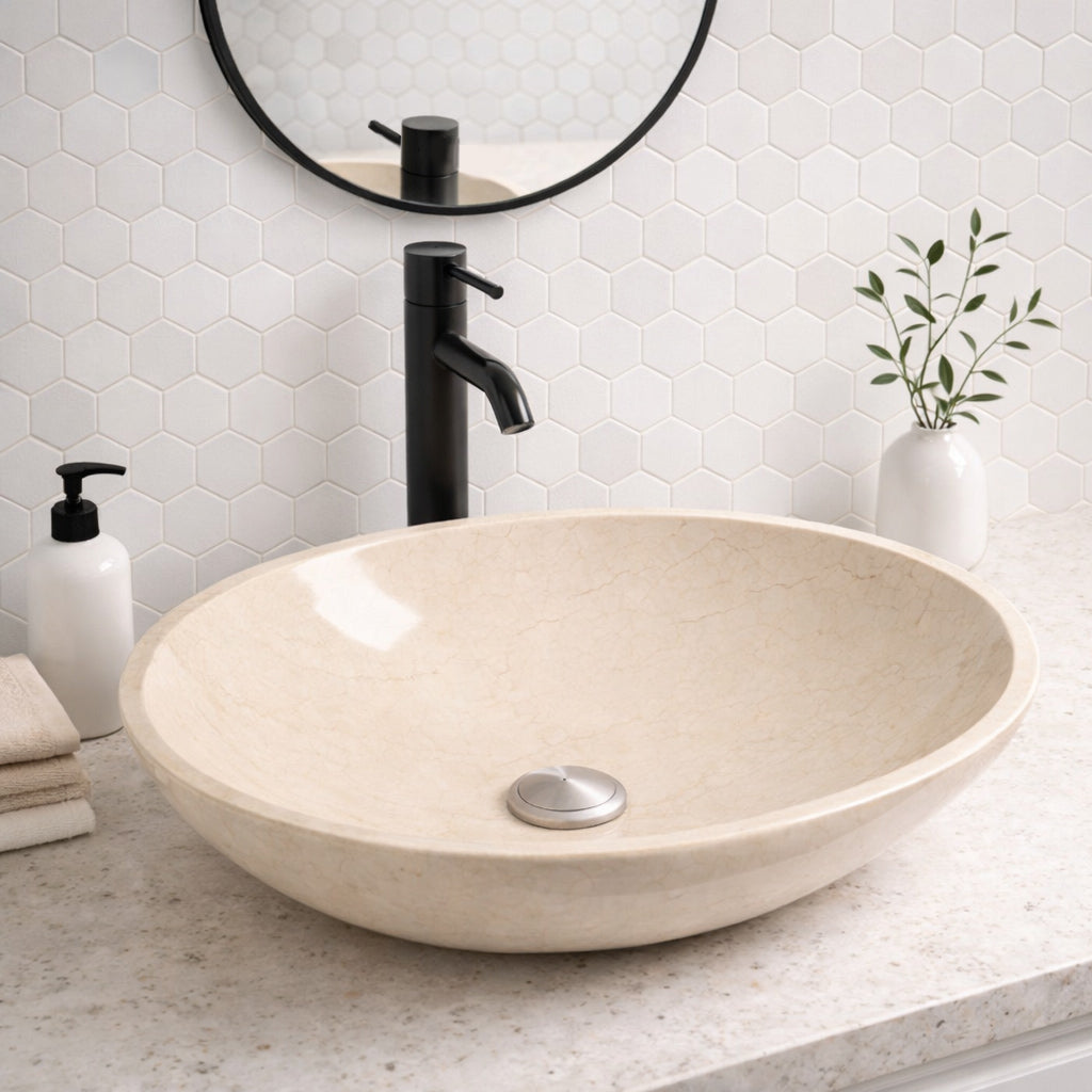 Unique bathroom sink featuring a handcrafted round beige marble vessel in an elegant bathroom setting.