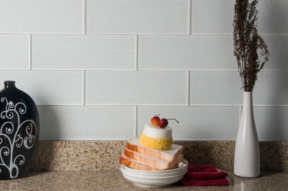 Bright living room featuring Linen Ice 3x8 glass wall tiles – delicate linen texture enhances modern interior design.