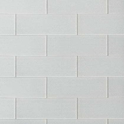 Linen ice 4-in x 12-in glass wall tiles with reflective surface, ideal for modern kitchen backsplashes and bathroom walls.
