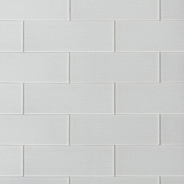 Linen ice 4-in x 12-in glass wall tiles with reflective surface, ideal for modern kitchen backsplashes and bathroom walls.