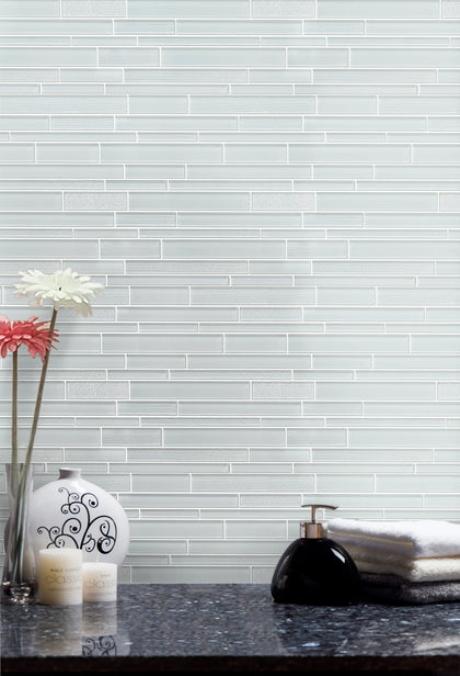 Living room accent wall with White Staccato Marble & Glass Random Strips Mosaic Tiles – white marble and glass strips adding a modern touch.