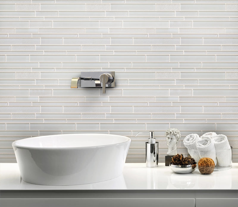Bathroom wall decorated with White Staccato Marble & Glass Random Strips Mosaic Tiles – clean and luminous white marble with glass details.