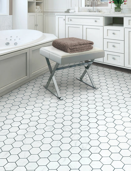 Honed Calacatta Gold hex tile in shower space – timeless style with subtle gold accents