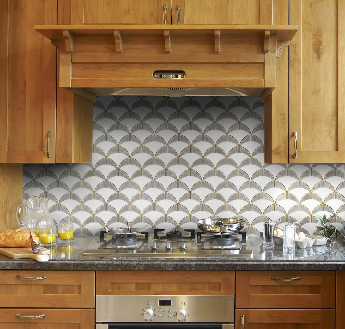 Kitchen backsplash with Thassos and Gray Shell Waterjet Mosaic – refined white and gray tones with elegant gold trim