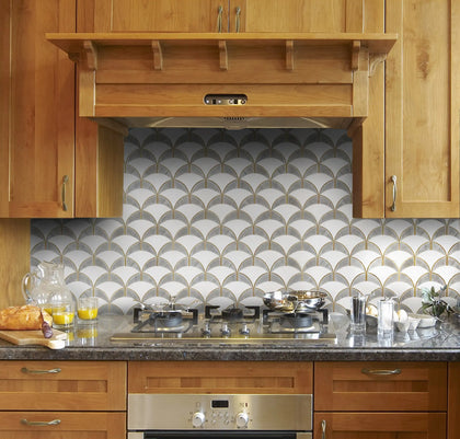 Kitchen backsplash with Thassos and Gray Shell Waterjet Mosaic – refined white and gray tones with elegant gold trim