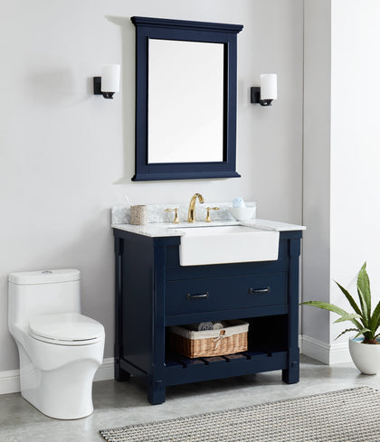 Navy blue bathroom vanity mirror above a stylish navy blue cabinet with a white sink and bathroom accessories.
