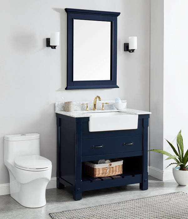 Navy blue bathroom vanity mirror above a stylish navy blue cabinet with a white sink and bathroom accessories.
