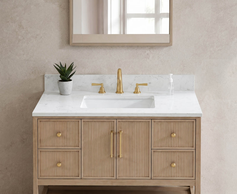 31-inch Carrara White Quartz vanity top with undermount sink and backsplash, styled on a natural wood fluted bathroom vanity with gold faucet.