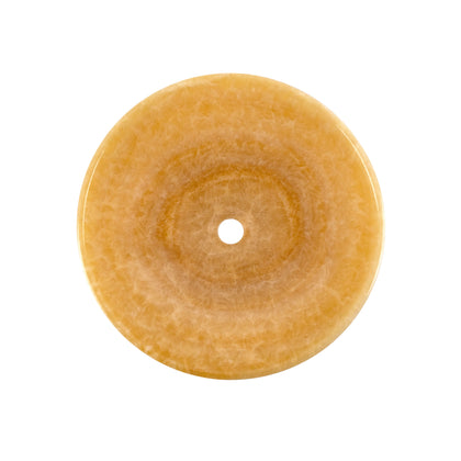 Decorative bathroom sink made of honey onyx marble, featuring a round design and warm amber color.