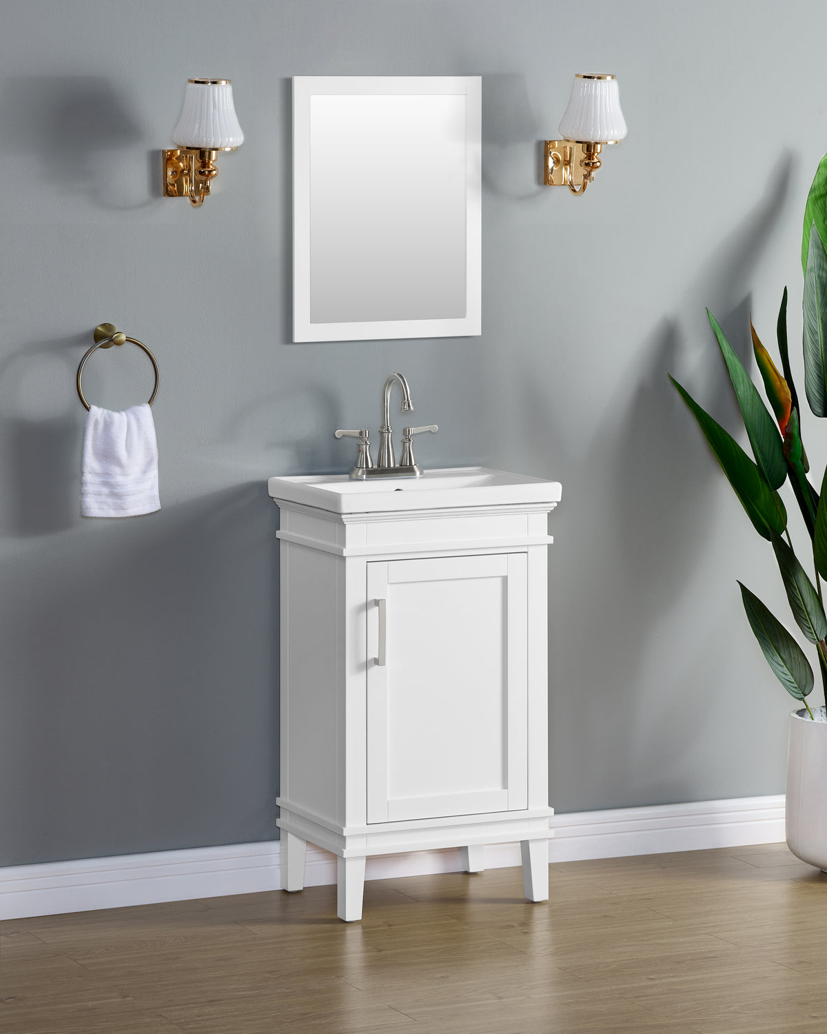 Elmington white vanity with porcelain top in a compact design for small spaces with mirror and wall sconces.