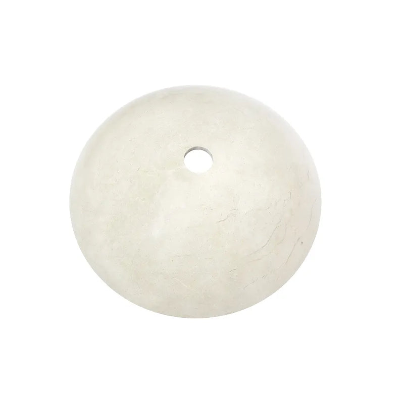 Carrara white marble vessel sink with a round design showcasing the natural stone texture and a central drain hole.