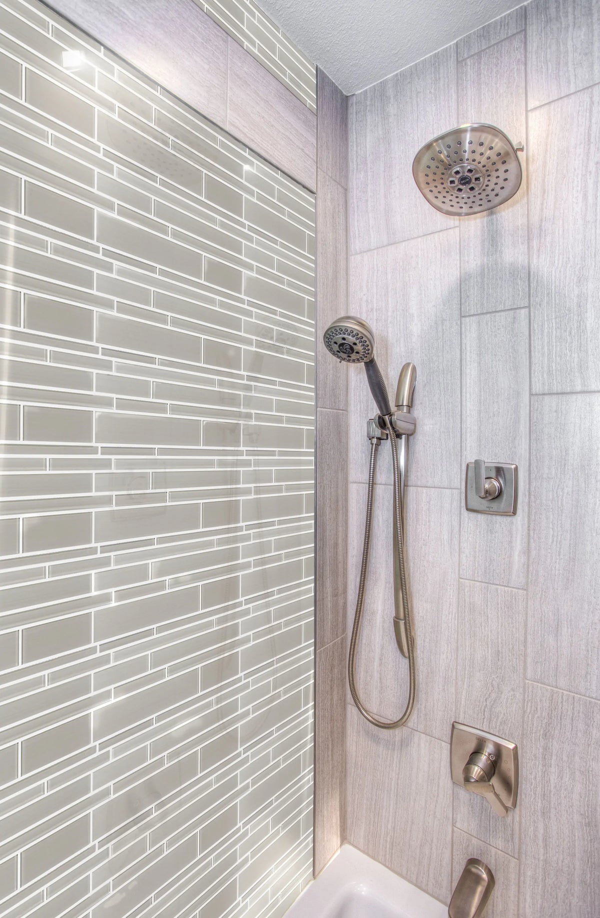 Bathroom wall tiled with Nude Denim Glass Mix Random Strip Mosaic Tiles – cool denim colors creating a refreshing atmosphere.