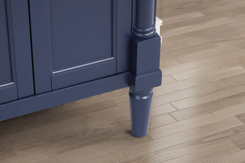Navy blue bathroom vanity corner detail showcasing elegant cabinetry and stylish legs on wooden floor.