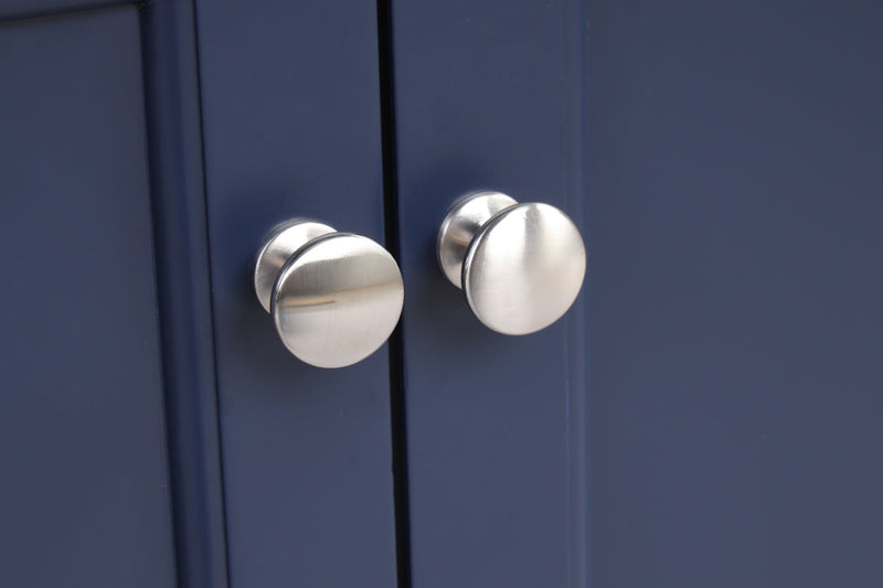 Close-up of modern cabinet knobs on a navy blue bathroom vanity.