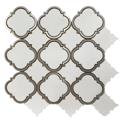 Close-up of Thassos Marble Waterjet Mosaic with Patterned Metal Trim – elegant polished tile combining luxury stone and metallic accents