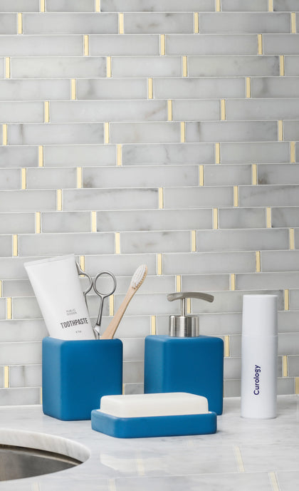 Living room feature wall with Calacatta and Gold Waterjet Mosaic Tile – bright white marble with shimmering gold detail adds a modern classic look