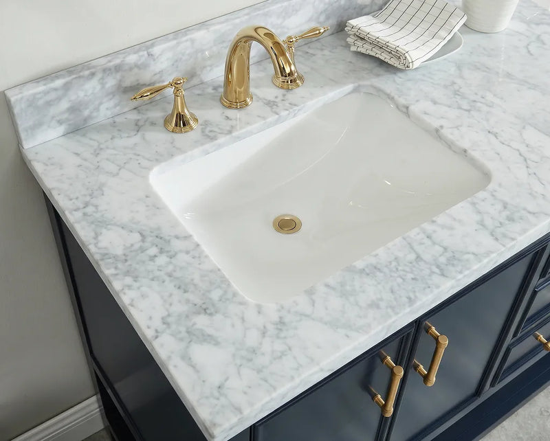 60 inch Manhattan vanity with Carrara marble top showcasing a white sink and gold faucets.