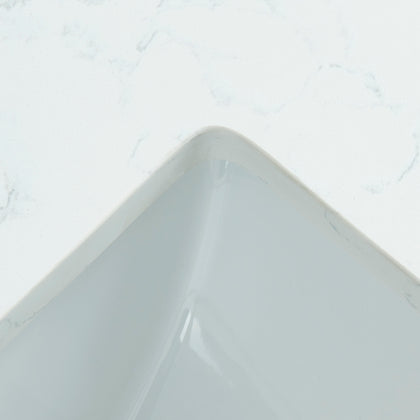 Detail view of a 31-inch Carrara White Quartz vanity top showing the undermount sink edge and subtle marble veining.